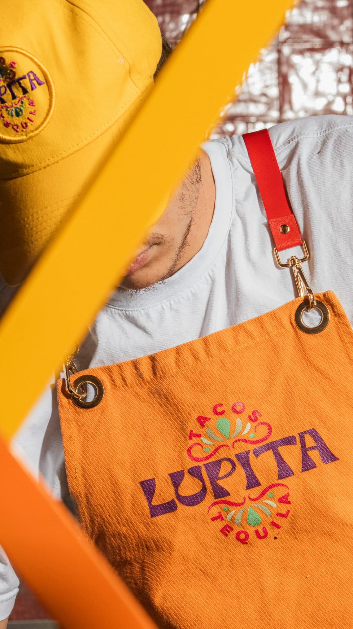 Close-up of the Lupita Tacos y Tequila logo embroidered on staff apparel
